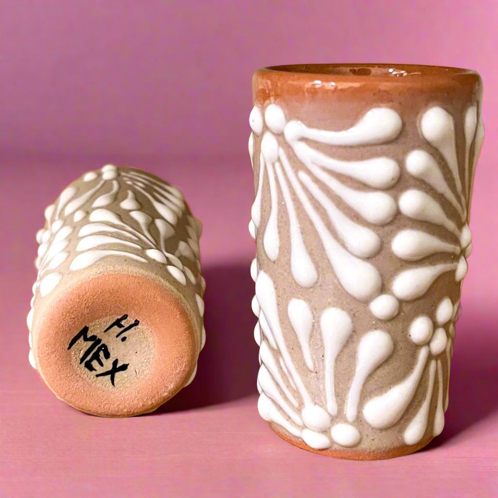 Two ceramic vases with decorative patterns on a wooden surface