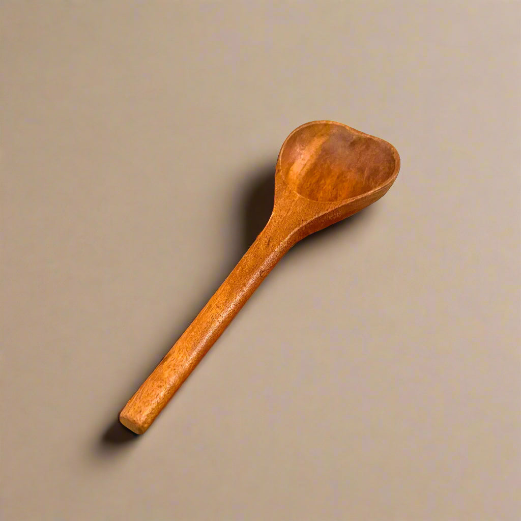 Wooden spoon on a beige background
