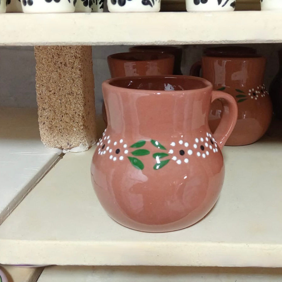 This classic Jarrito mug, made from traditional barro clay, is perfect for enjoying your favorite drinks. Handmade in Mexico, it brings rustic charm and authenticity to your table.