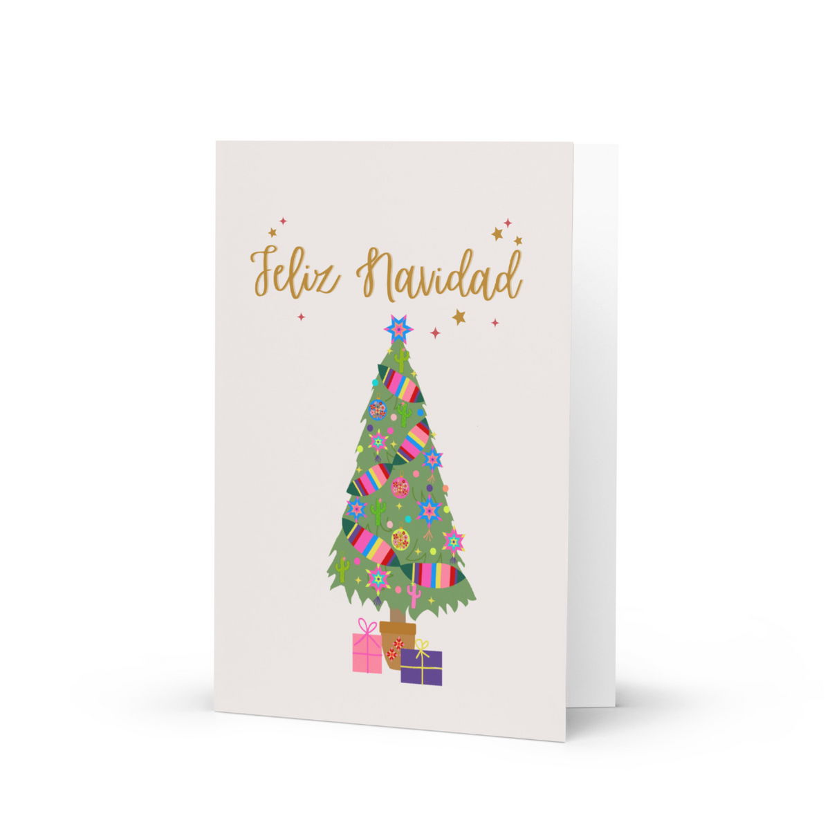 A Christmas greeting card with a light beige background, featuring the Spanish text 'Feliz Navidad' in gold script above an illustrated green Christmas tree decorated with colorful gifts, ornaments, and stars, with small wrapped presents at the base.