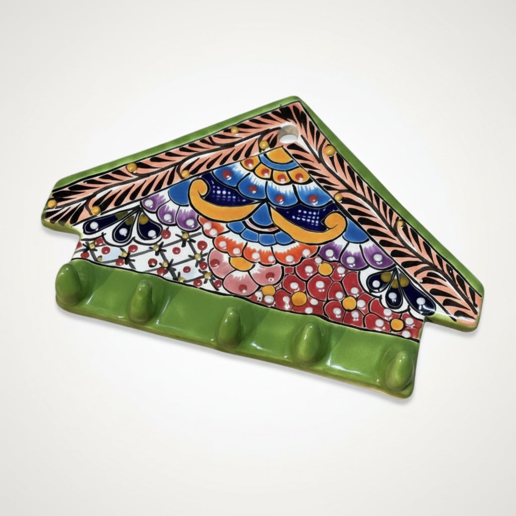 Colorful ceramic trivet with decorative patterns on a light purple background