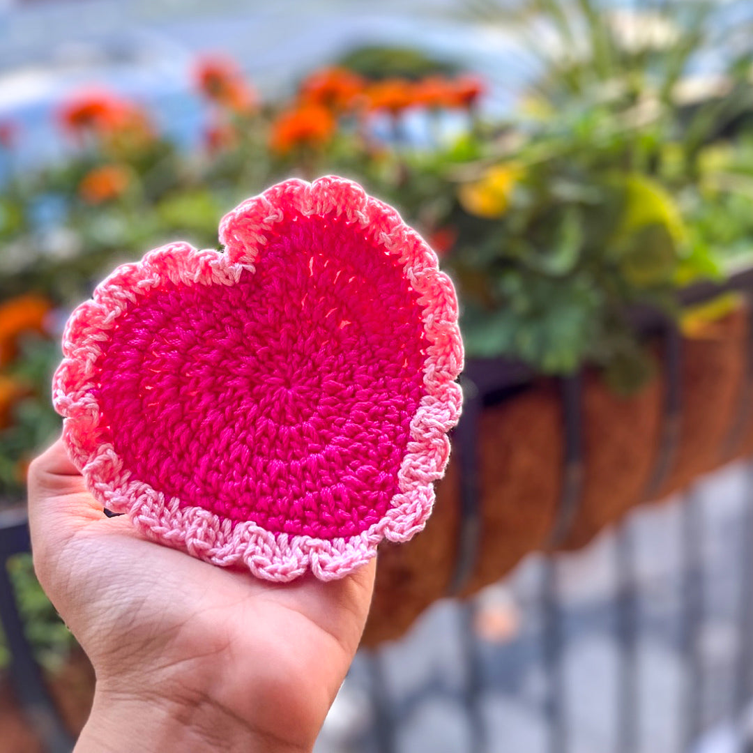 Handcrafted dark pink crochet coaster with a rich texture and elegant design.