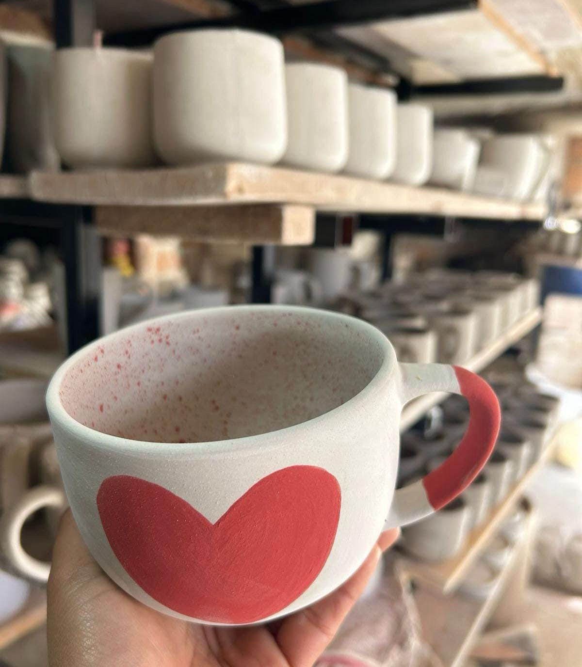 Handcrafted, unfinished large heart-shaped mug made in Mexico, currently in the making at our ceramic shop. The mug is in its raw state highlighting the intricate craftsmanship in progress. &lt;3