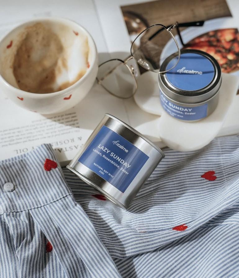 Heart mug filled with coffee and cream on a desk with glasses, cozy busy day feel