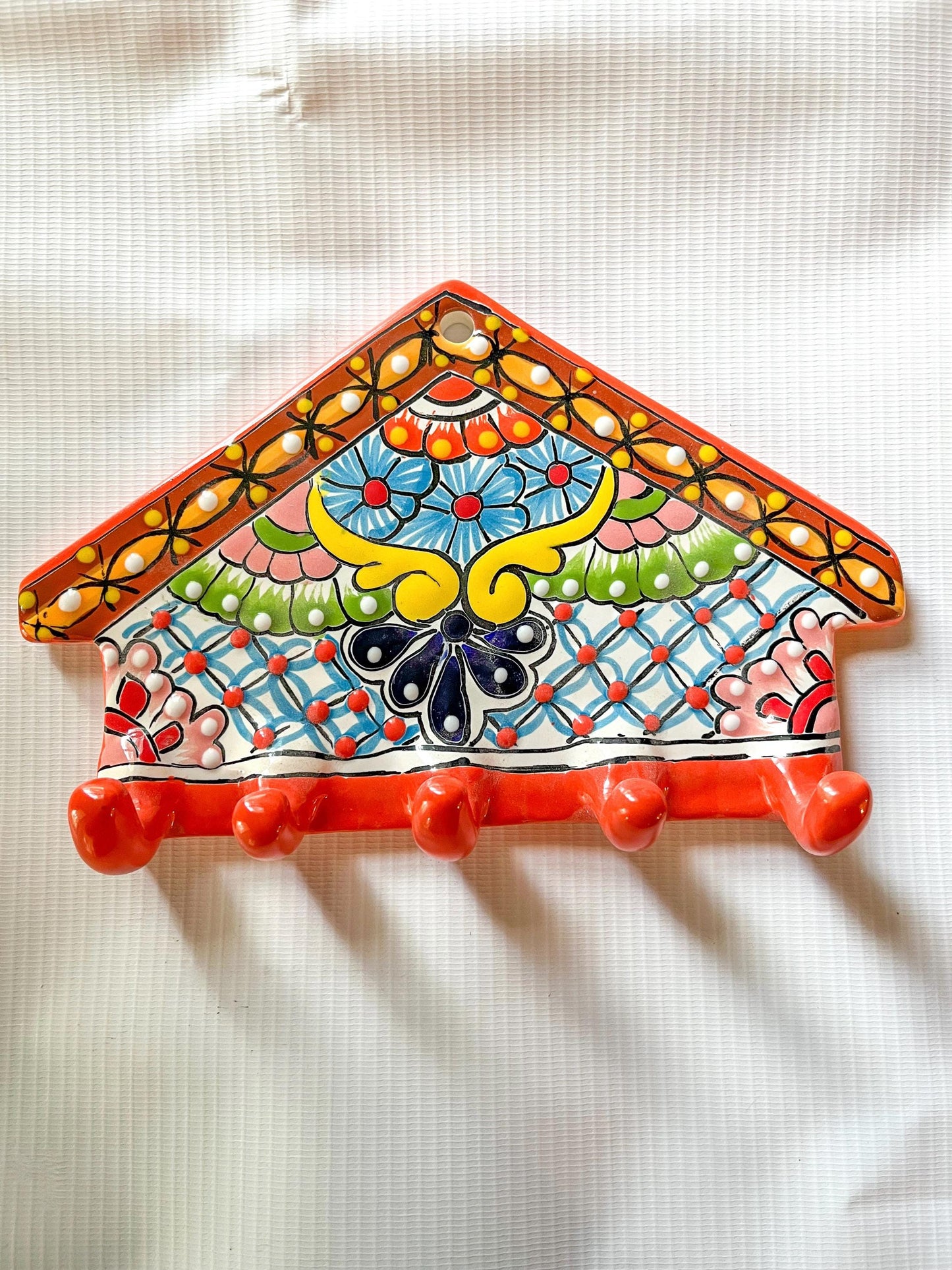 Decorative key holder with colorful patterns on a white background