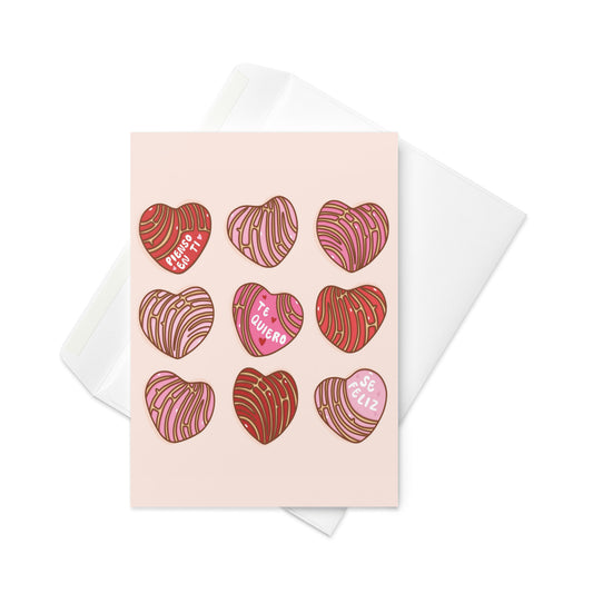 A bright Pan Concha Hearts card with cute heart designs. The card has the messages 'Pienso en ti,' 'Te quiero,' and 'Sé feliz,' making it a lovely way to share love and happiness with friends and family.