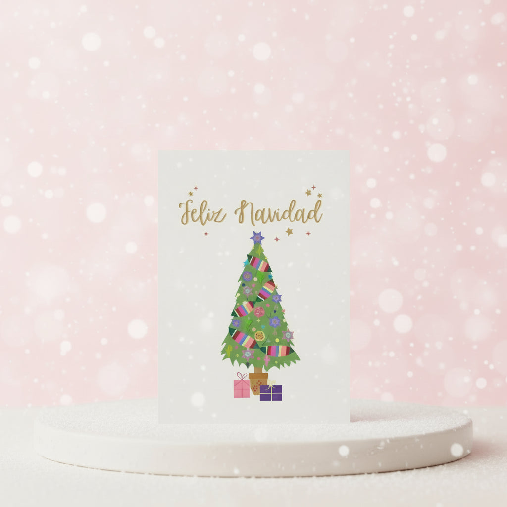 Festive Christmas card with a colorful tree and 'Feliz Navidad' text on a pink background.