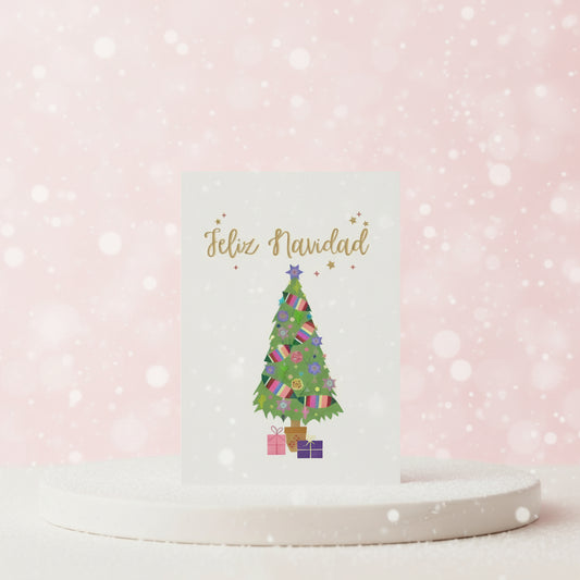 Festive Christmas card with a colorful tree and 'Feliz Navidad' text on a pink background.